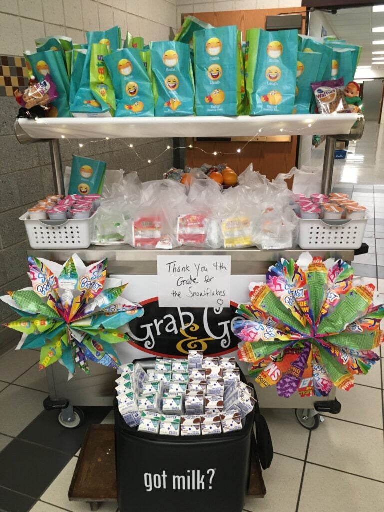 School Breakfast Cart decorated with student decorations, filled with breakfast items