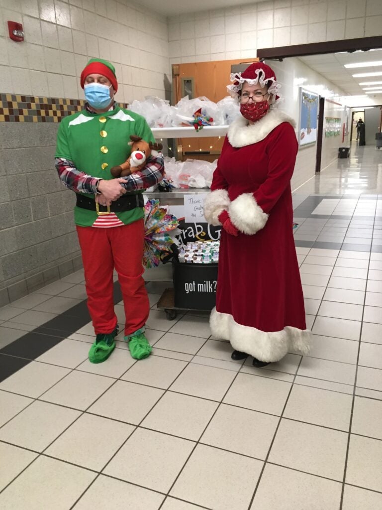 School staff dressed in holiday costumes with breakfast cart