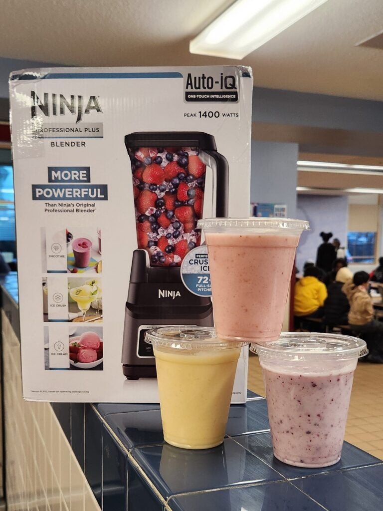 A stack of smoothies next to a blender