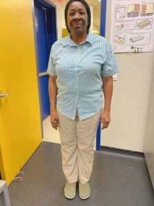 Ms. Johnson wears a blue button down and looks at the camera