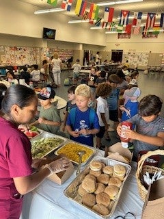 Kids get served food