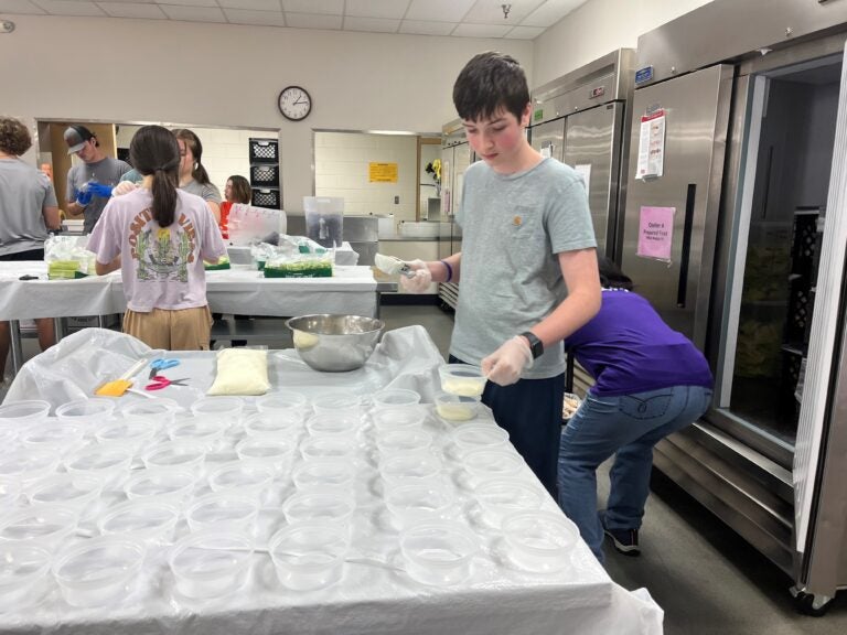 Students pack meals for distribution